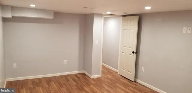 a view of hallway with wooden floor