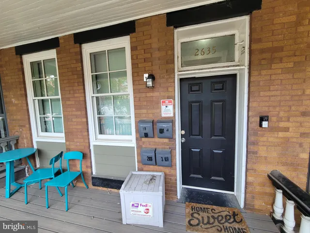 a front view of a house with outdoor seating