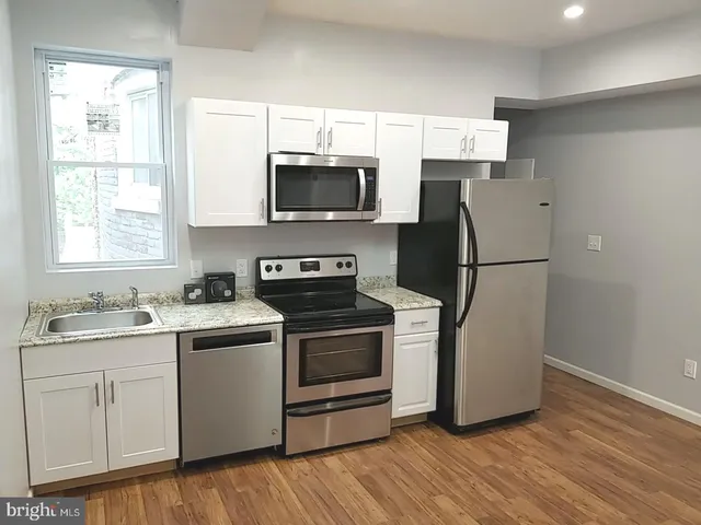 a kitchen with a refrigerator stove and sink
