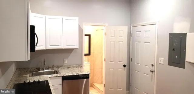 a kitchen with a refrigerator and a sink