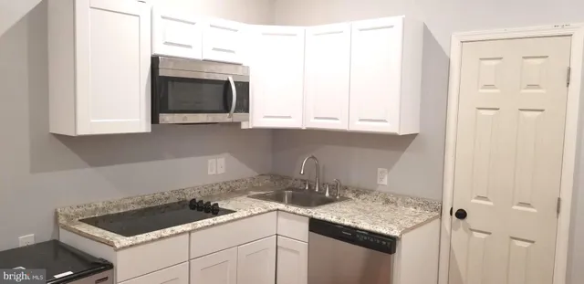 a kitchen with a sink and cabinets