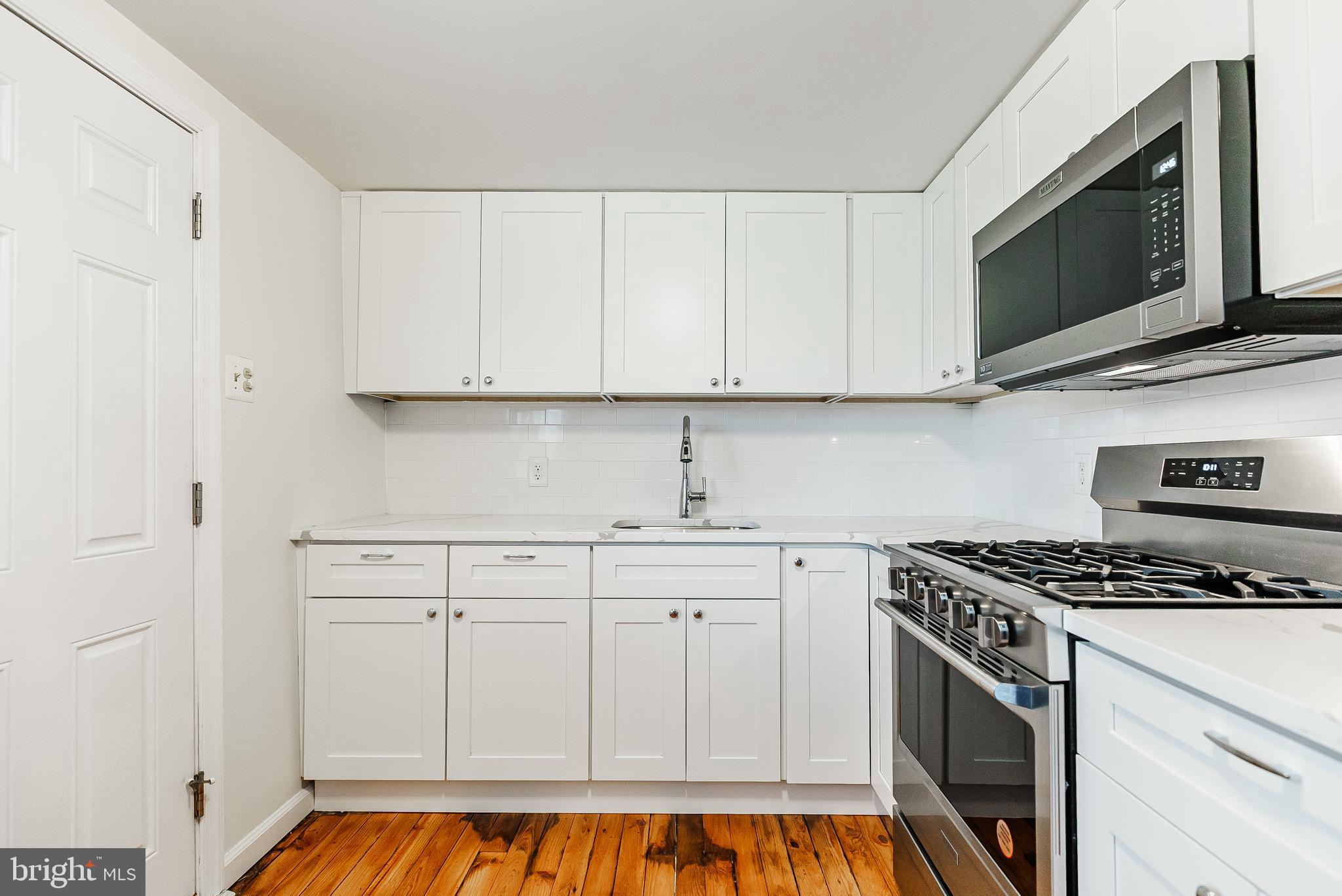 431 Central Avenue Glenside, PA 19038 - Photo 6 of 15 a kitchen with white cabinets and appliances