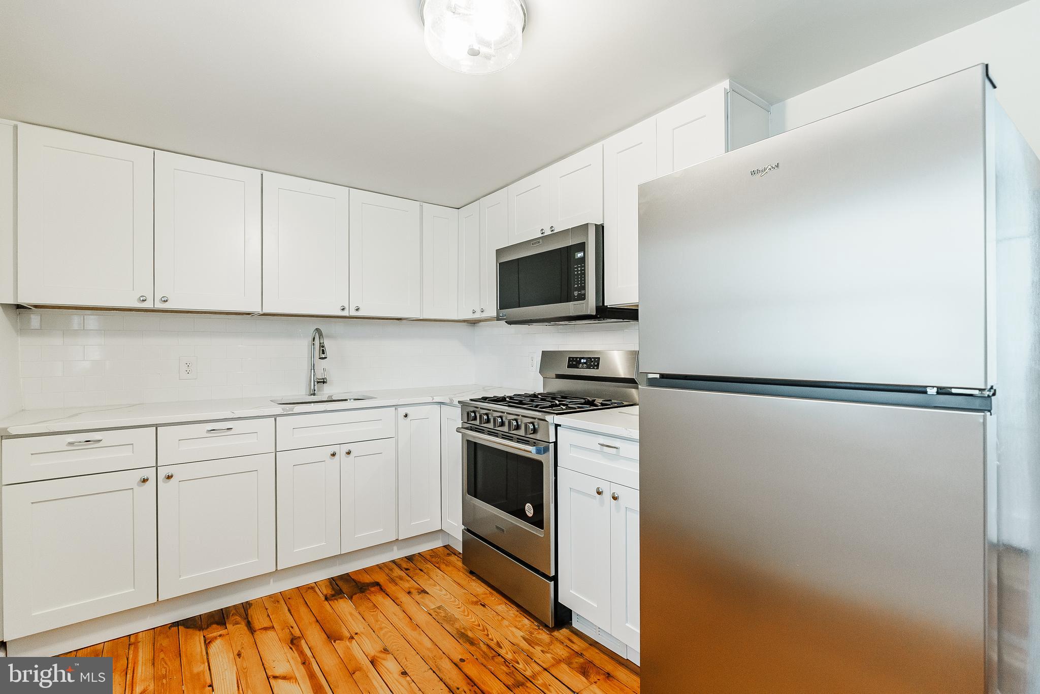431 Central Avenue Glenside, PA 19038 - Photo 7 of 15 a kitchen with cabinets stainless steel appliances and a counter space