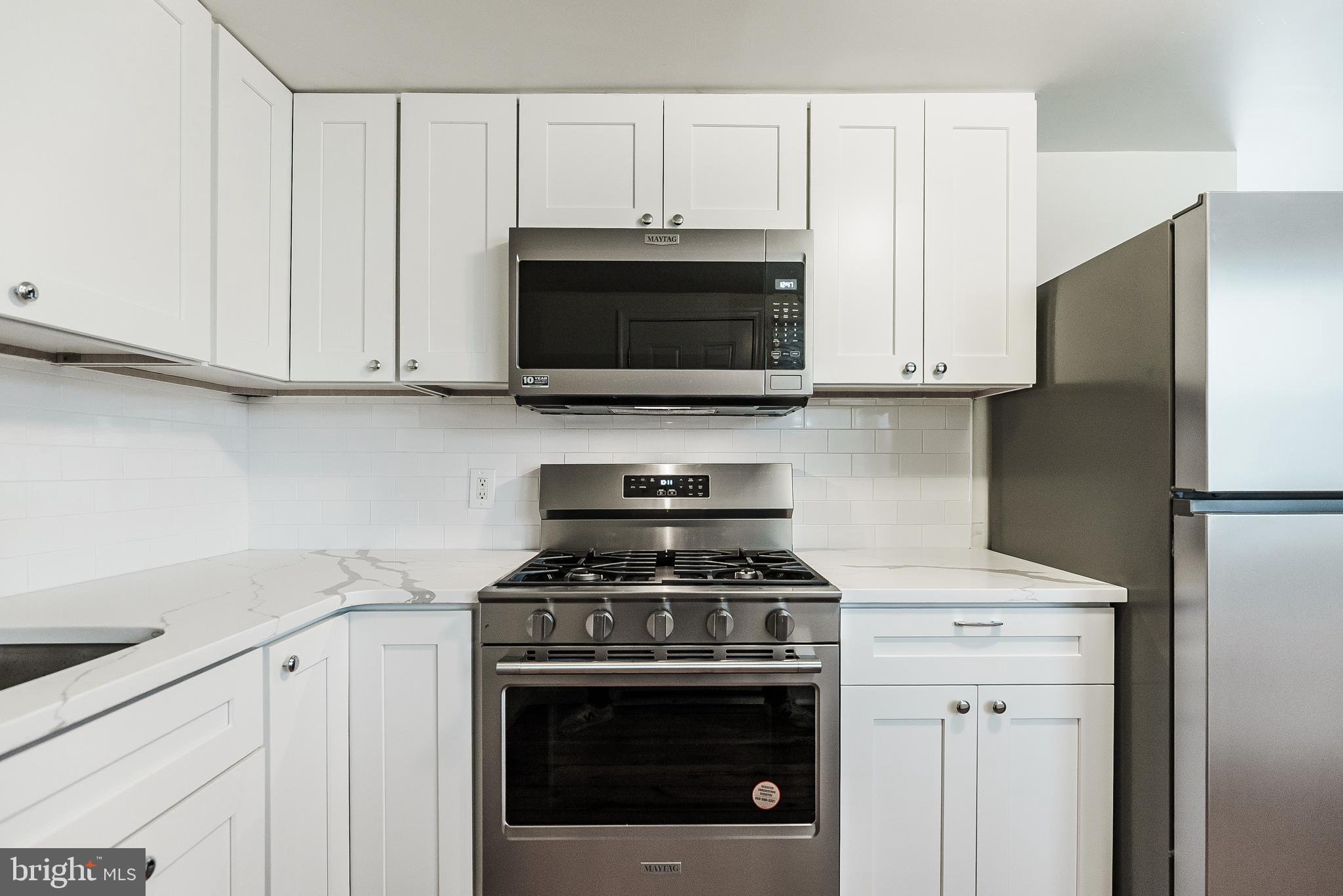 431 Central Avenue Glenside, PA 19038 - Photo 8 of 15 a kitchen with granite countertop white cabinets and stainless steel appliances
