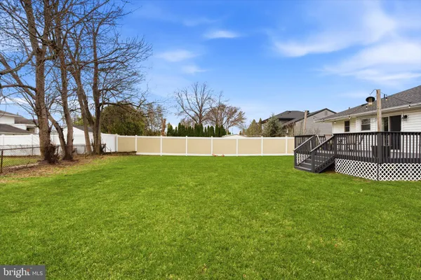 a view of yard with grass and trees