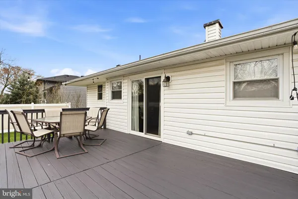 a view of a deck with table and chairs and wooden floor