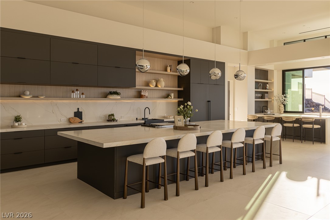 563 Grand Rim Drive Henderson, NV 89012 - Photo 7 of 70 Culinary aspirations meet design with this spacious kitchen, featuring a grand island and generous counter space.