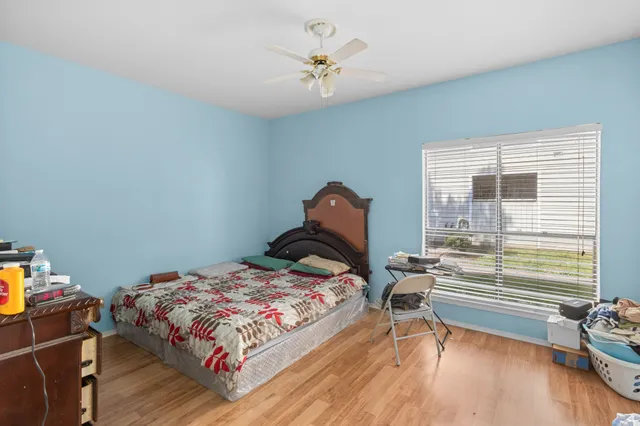a bedroom with a bed and a chandelier