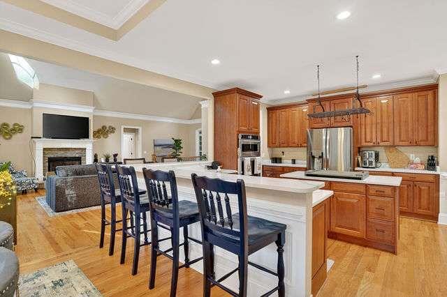 8179 Pineview Court Villa Rica, GA 30180 - Photo 7 of 41 a kitchen with stainless steel appliances granite countertop wooden floor a dining table and chairs