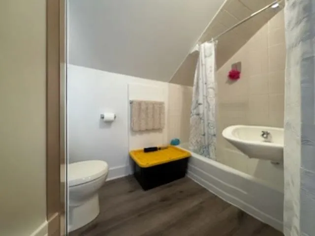 a room with furniture and a chandelier fan