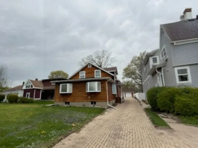a front view of a house with a garden and yard
