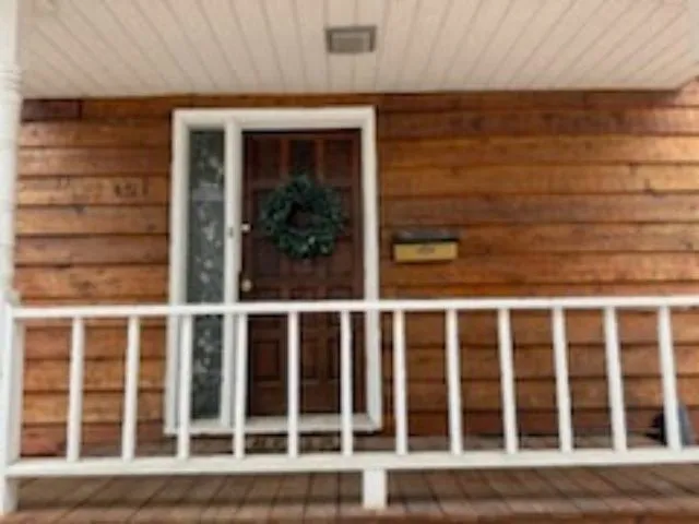 a house that has a tree in front of it