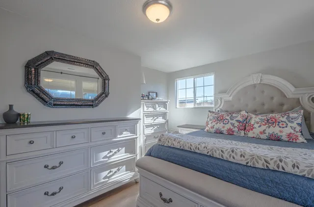 a bedroom with a bed and a mirror