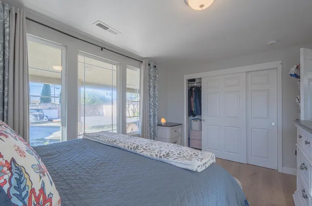 a bedroom with a bed and a large mirror