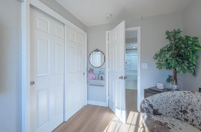 a bedroom with a bed and a potted plant