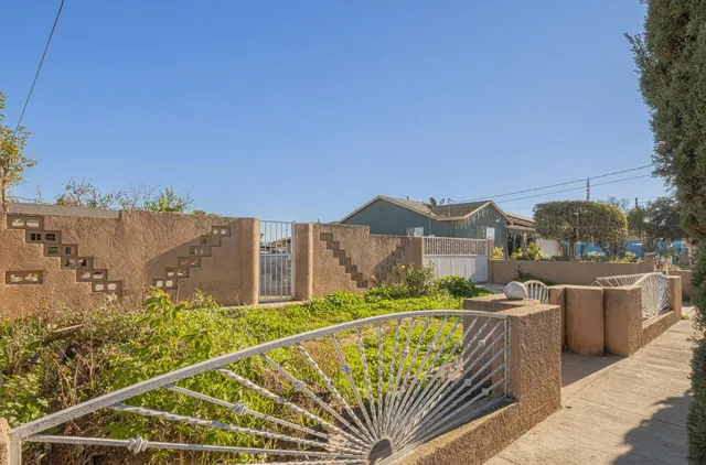 a view of a balcony with a floor to ceiling window and wooden fence