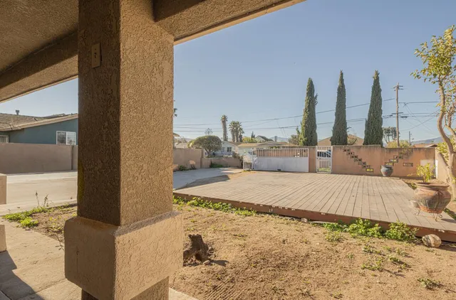 a spacious bedroom with a large bed and a chandelier