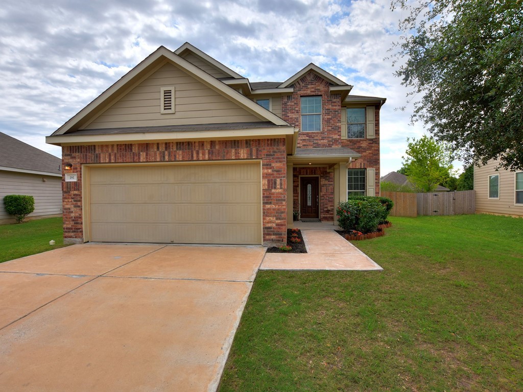 181 Barn Owl Loop Leander, TX 78641 - Photo 1 of 1 a front view of a house with a yard and trees