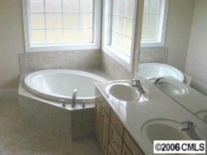 3614 Haigler Road Monroe, NC 28110 - Photo 7 of 7 a bath tub sitting in a bathroom next to a window