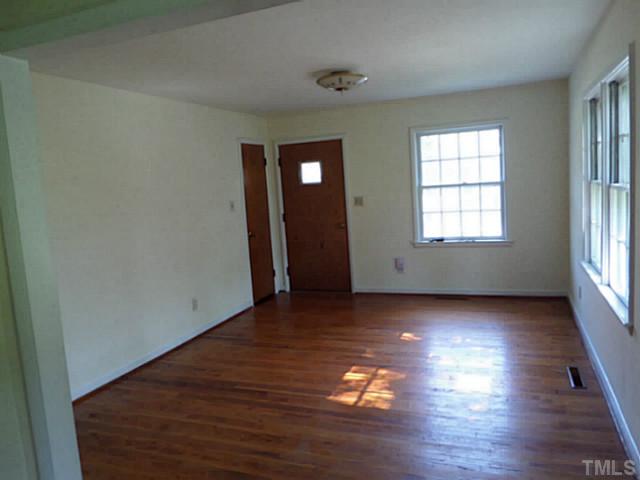 508 Doby Circle Raleigh, NC 27610 - Photo 12 of 13 an empty room with wooden floor and windows