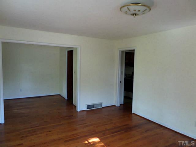 508 Doby Circle Raleigh, NC 27610 - Photo 4 of 13 an empty room with wooden floor and windows
