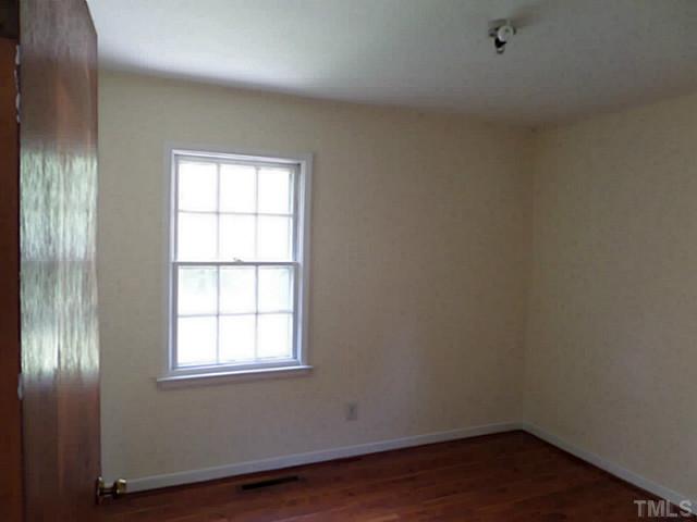 508 Doby Circle Raleigh, NC 27610 - Photo 6 of 13 an empty room with wooden floor and windows