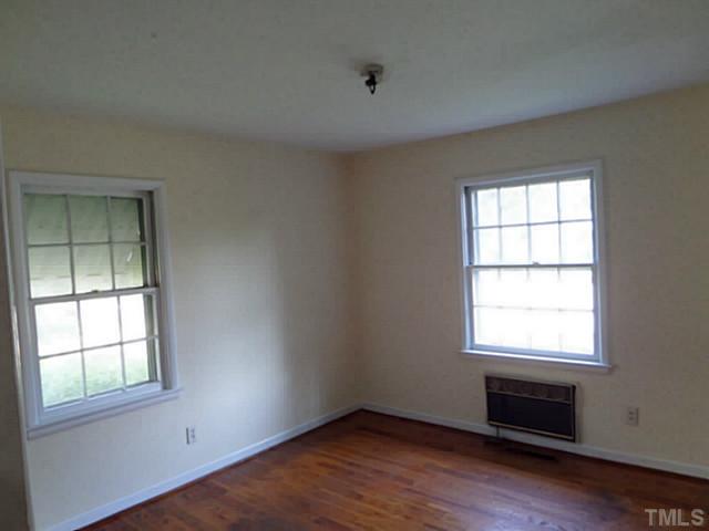 508 Doby Circle Raleigh, NC 27610 - Photo 7 of 13 an empty room with wooden floor and windows