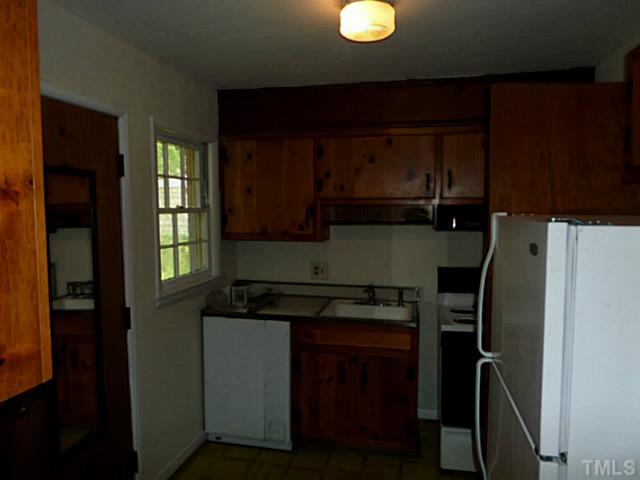 508 Doby Circle Raleigh, NC 27610 - Photo 8 of 13 a kitchen with a refrigerator and a stove top oven