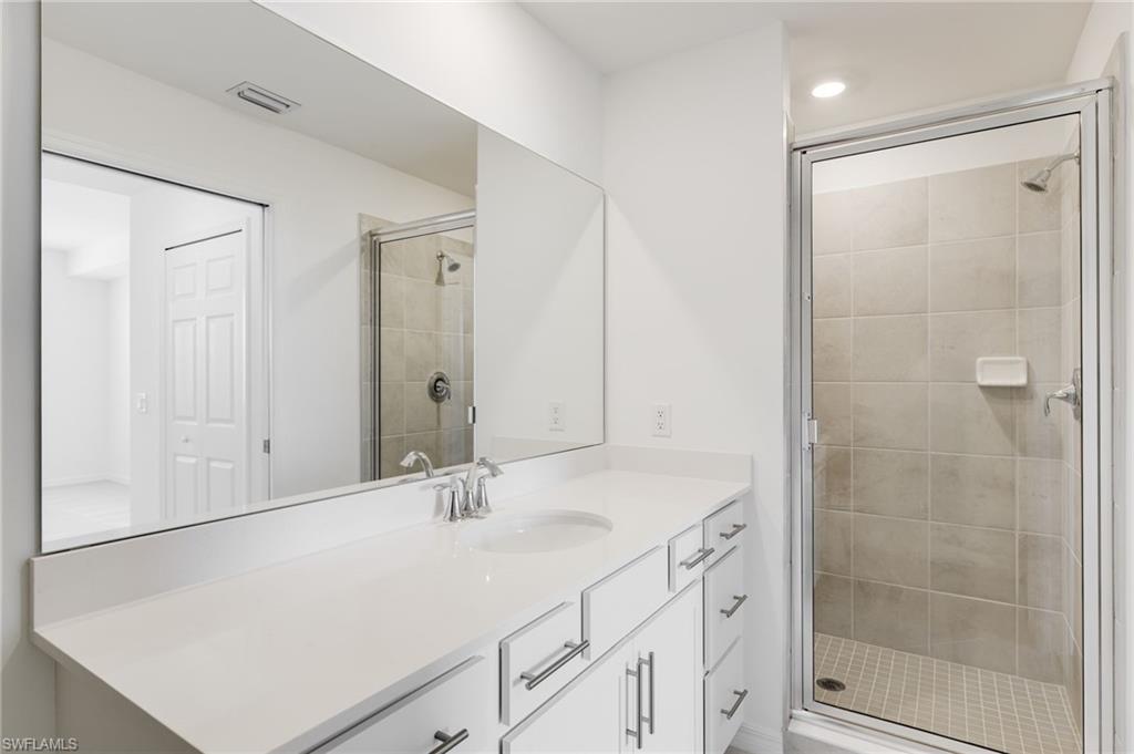 43981 Boardwalk Loop, Unit 2225 Punta Gorda, FL 33982 - Photo 12 of 48 a bathroom with a shower sink and mirror