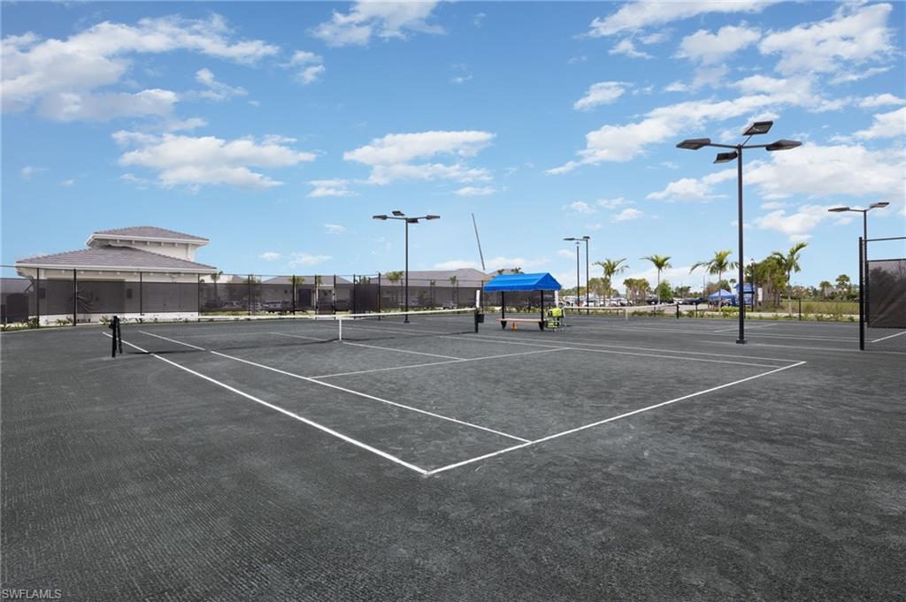 43981 Boardwalk Loop, Unit 2225 Punta Gorda, FL 33982 - Photo 40 of 48 a view of a tennis ground with tables and chairs