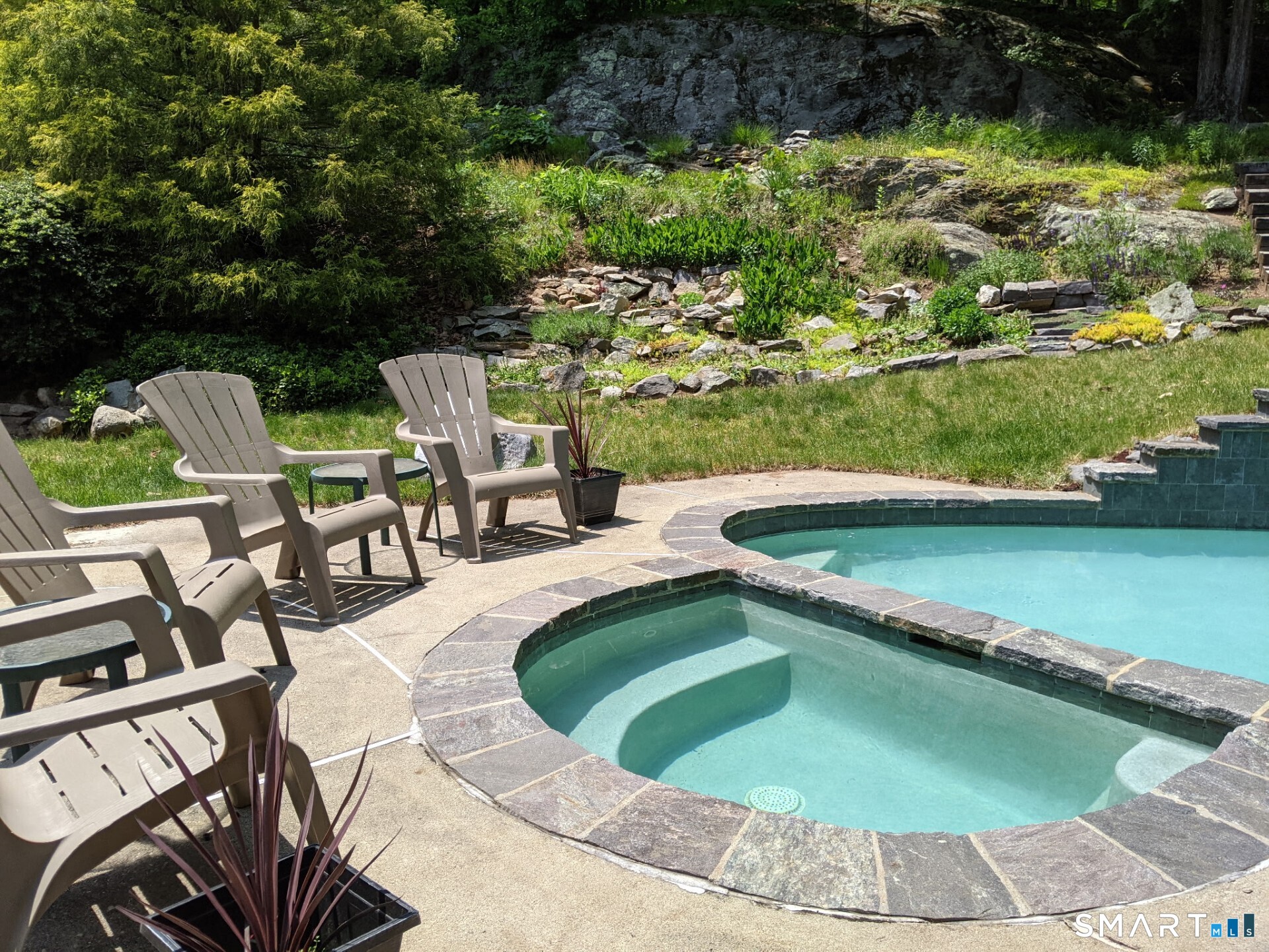 122 Ridgeview Circle Guilford, CT 06437 - Photo 30 of 40 Heated pool and spa surrounded by natural outcroppings and mature plantings. This property abuts Land Trust, offering the ultimate in privacy and relaxation. You'll never want to leave home!