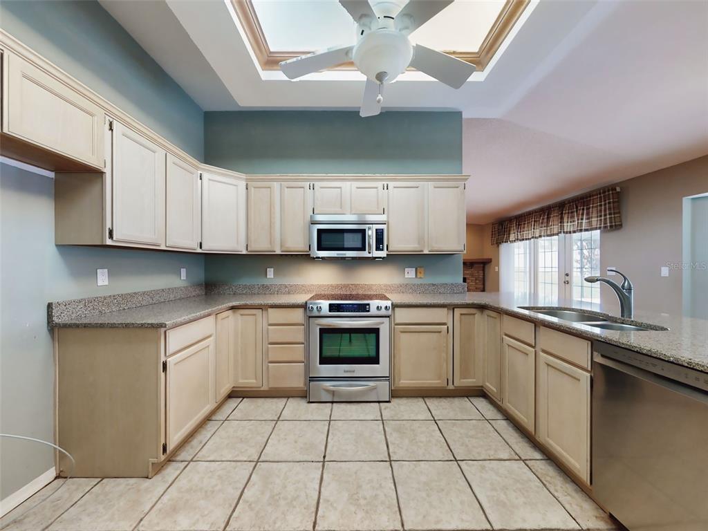 116 Wood Ridge Trail Sanford, FL 32771 - Photo 11 of 49 a kitchen with stainless steel appliances granite countertop a sink and cabinets