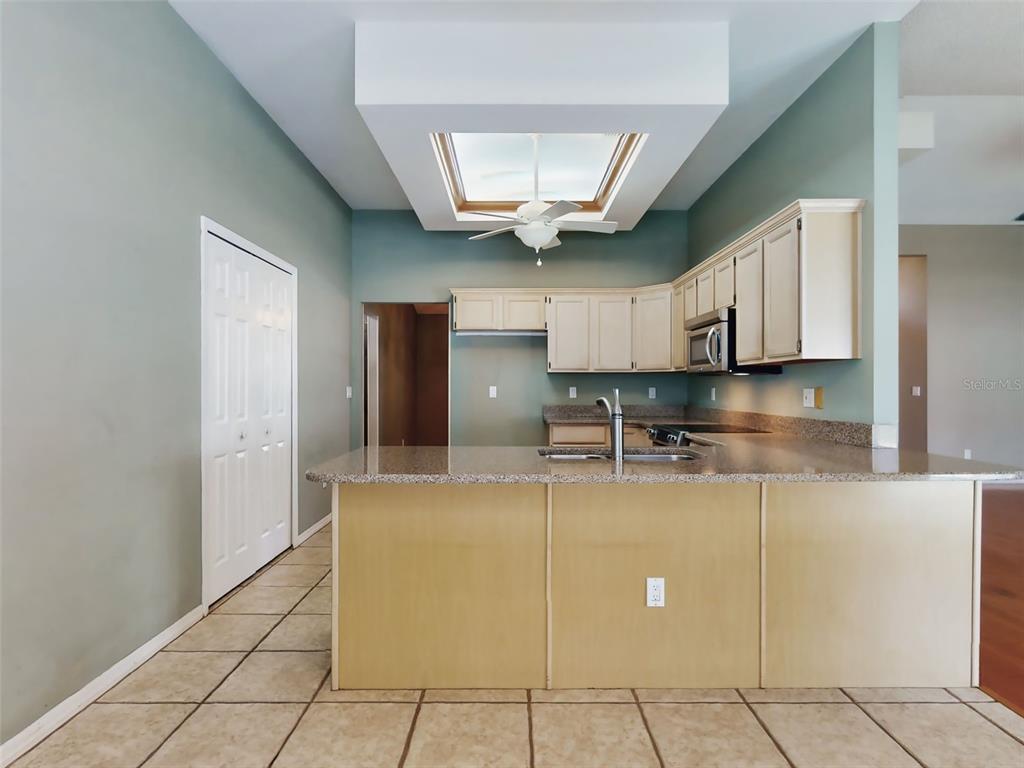 116 Wood Ridge Trail Sanford, FL 32771 - Photo 12 of 49 a kitchen with kitchen island granite countertop a refrigerator a stove and a sink
