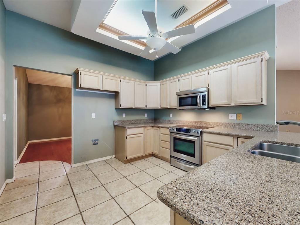 116 Wood Ridge Trail Sanford, FL 32771 - Photo 13 of 49 a kitchen with stainless steel appliances granite countertop a sink and a stove