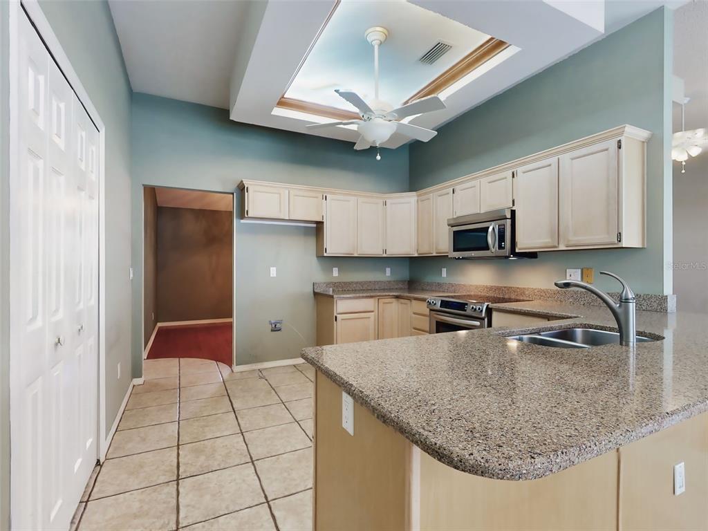 116 Wood Ridge Trail Sanford, FL 32771 - Photo 14 of 49 a kitchen with stainless steel appliances granite countertop a sink dishwasher and a refrigerator