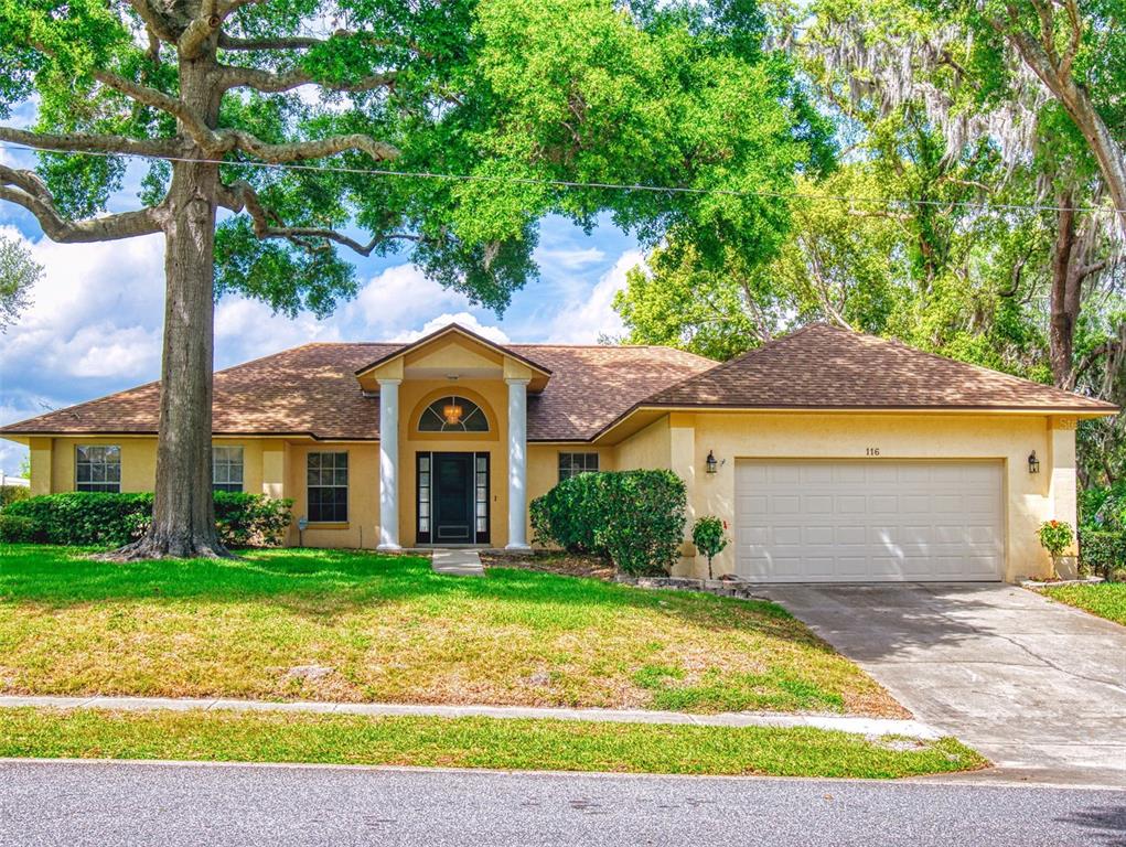 116 Wood Ridge Trail Sanford, FL 32771 - Photo 18 of 49 a front view of a house with garden