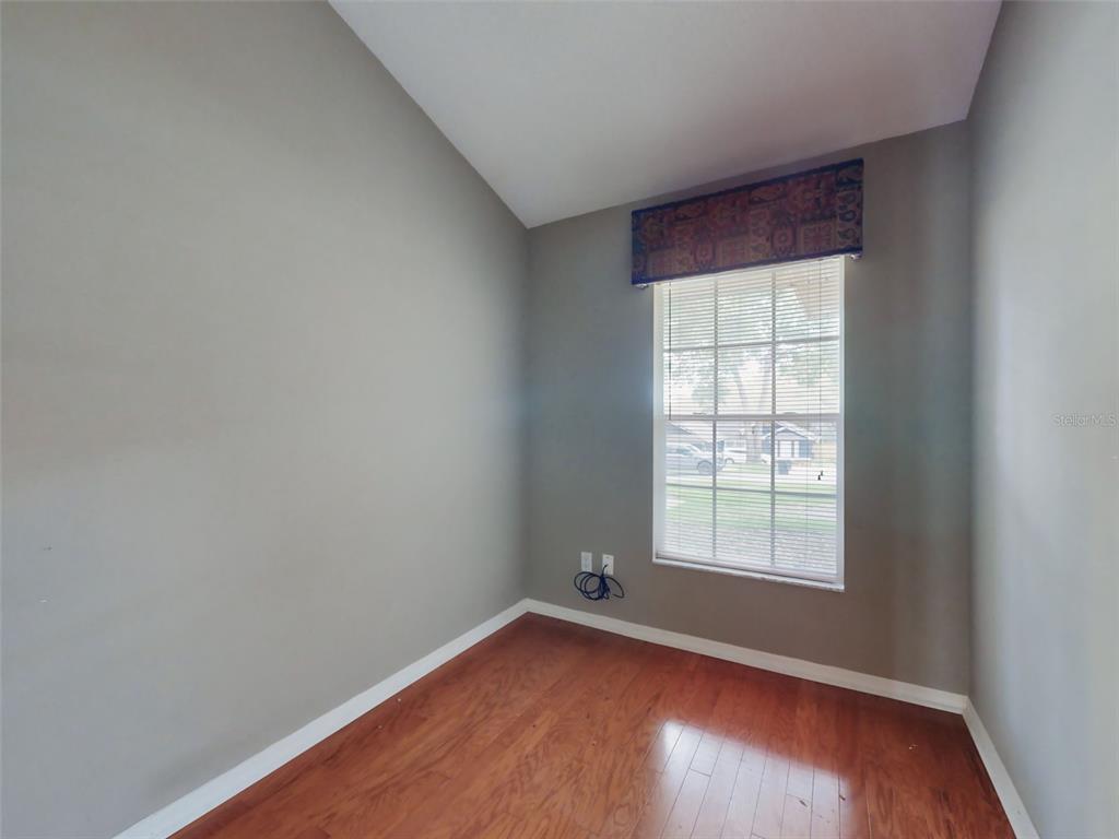 116 Wood Ridge Trail Sanford, FL 32771 - Photo 22 of 49 an empty room with wooden floor and windows