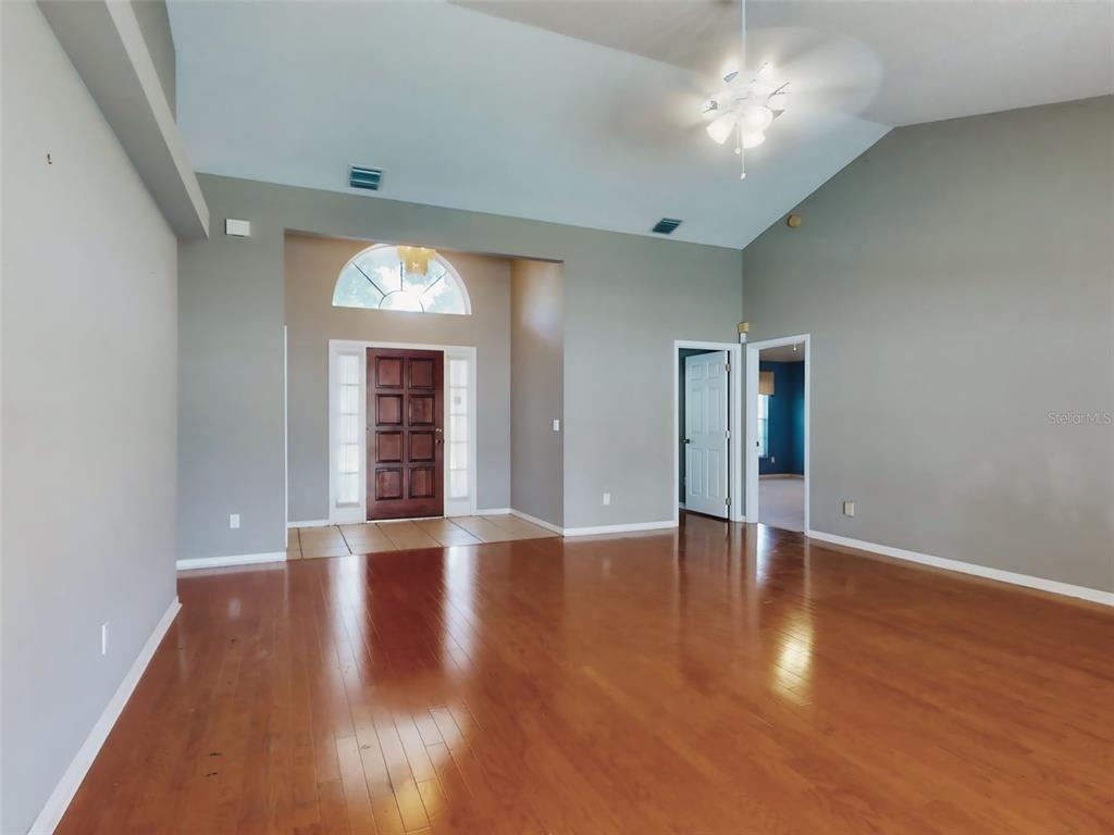 116 Wood Ridge Trail Sanford, FL 32771 - Photo 3 of 49 a view of an empty room with wooden floor and a window