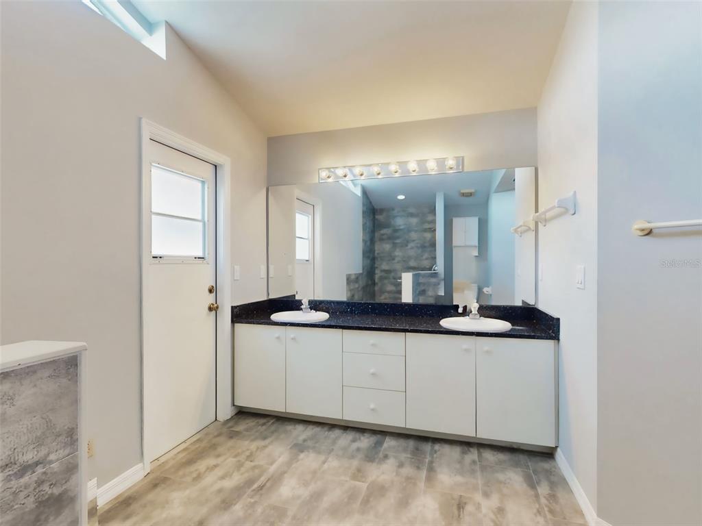 116 Wood Ridge Trail Sanford, FL 32771 - Photo 32 of 49 a kitchen with granite countertop a sink and cabinets