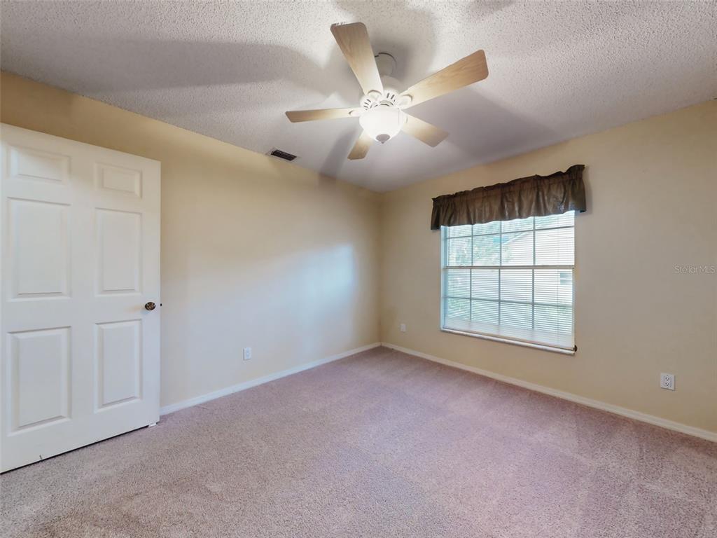 116 Wood Ridge Trail Sanford, FL 32771 - Photo 35 of 49 an empty room with chandelier fan and windows