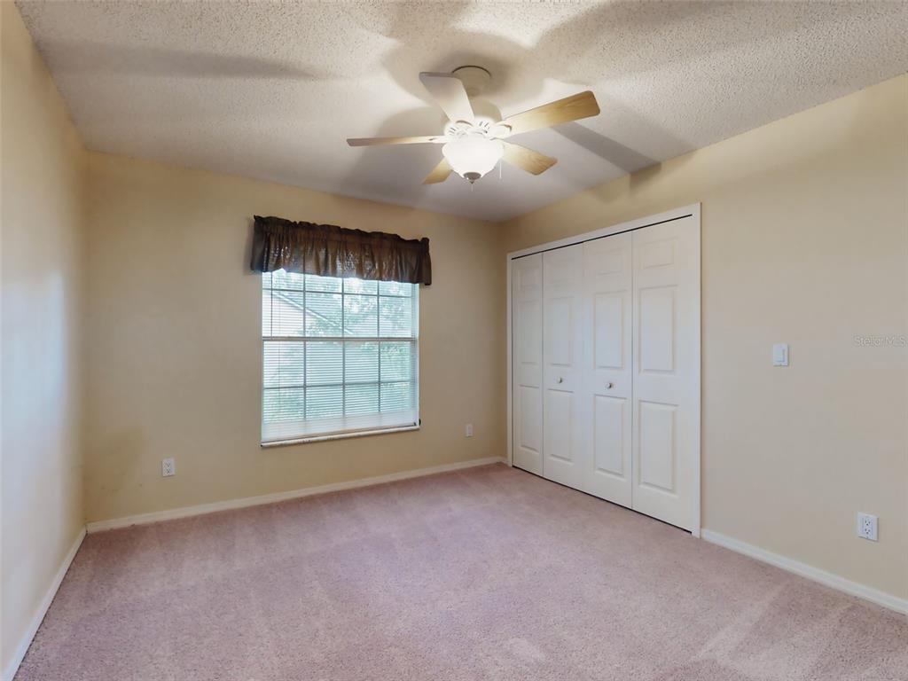 116 Wood Ridge Trail Sanford, FL 32771 - Photo 37 of 49 an empty room with chandelier fan and windows