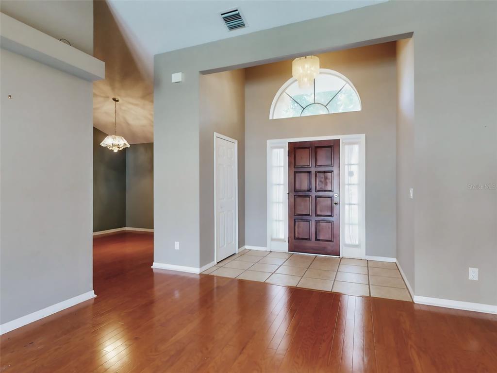 116 Wood Ridge Trail Sanford, FL 32771 - Photo 4 of 49 an empty room with wooden floor and a window