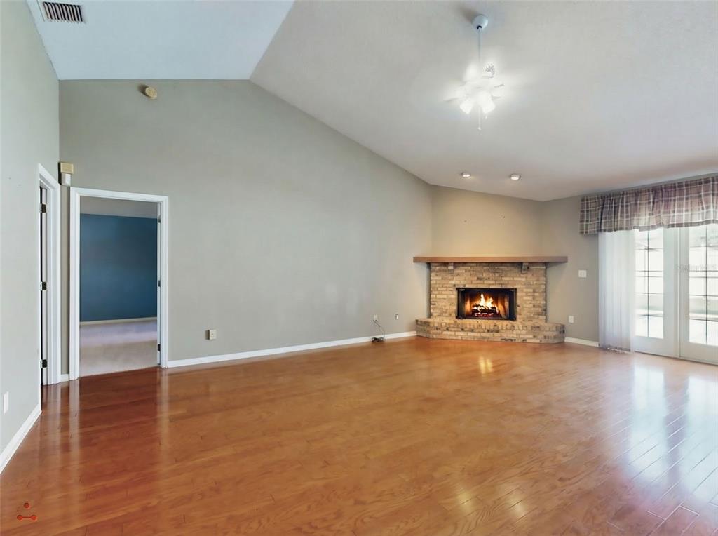 116 Wood Ridge Trail Sanford, FL 32771 - Photo 7 of 49 an empty room with wooden floor and fireplace