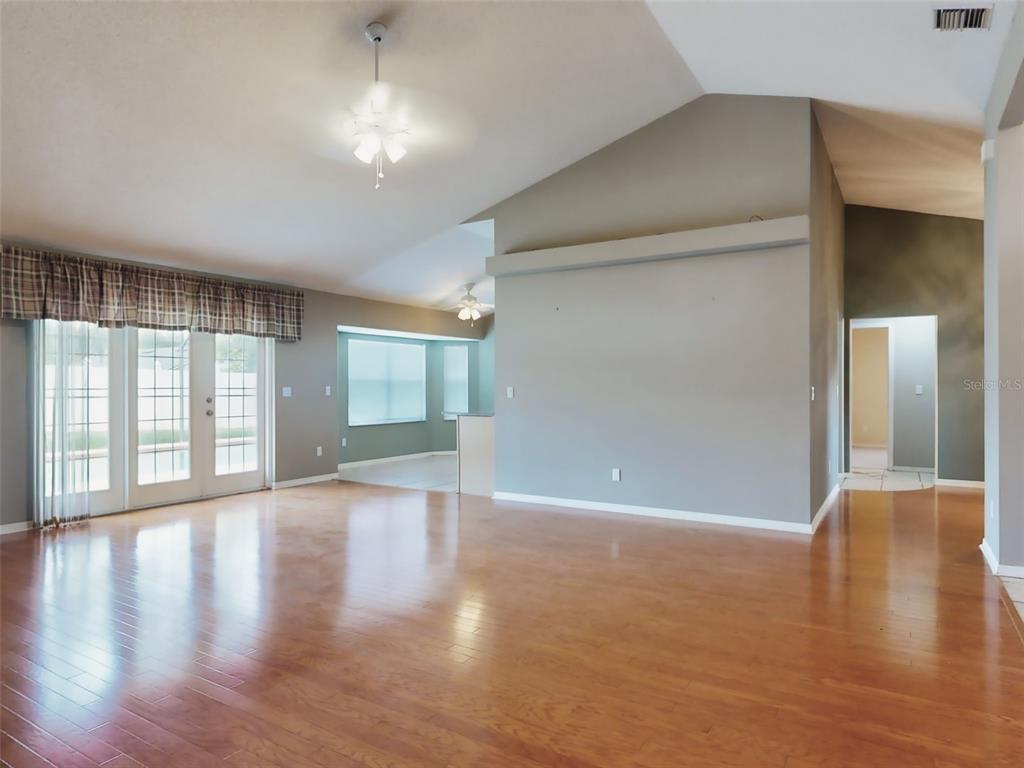 116 Wood Ridge Trail Sanford, FL 32771 - Photo 8 of 49 a view of an empty room with wooden floor and a window