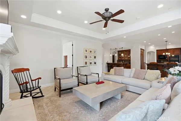 a kitchen with stainless steel appliances granite countertop a stove a refrigerator and a view of living room