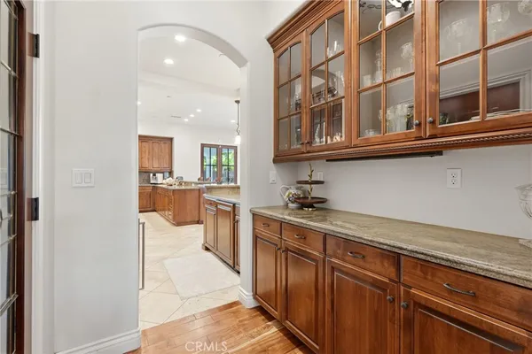 a kitchen with stainless steel appliances granite countertop a sink and a refrigerator