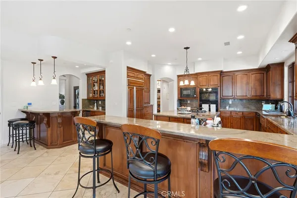 a kitchen with stainless steel appliances granite countertop a sink refrigerator and microwave