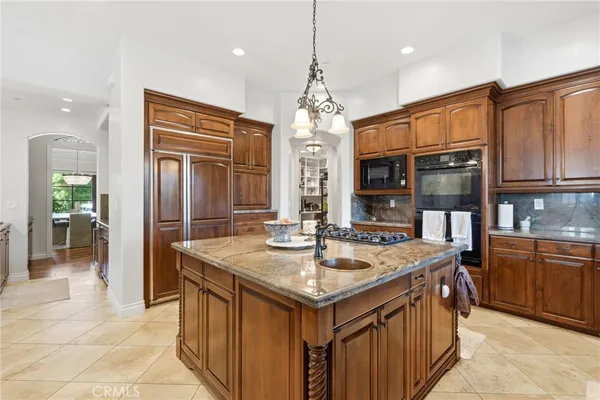 a bathroom with a granite countertop sink toilet and mirror