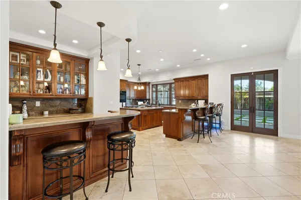 a living room with furniture a fireplace and a chandelier