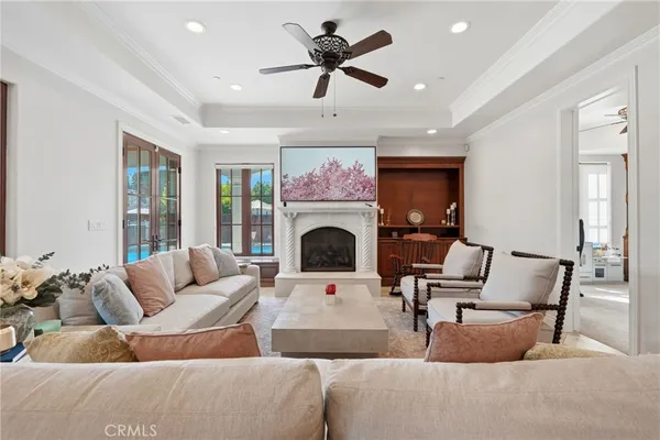 a living room with furniture a fireplace and a flat screen tv